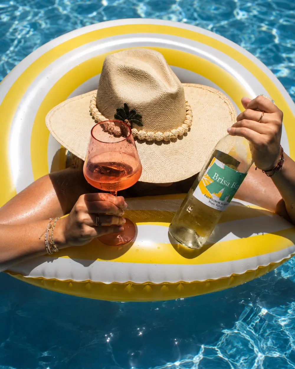 A pool float afternoon with a bottle of Brisa Bay Sauvignon Blanc